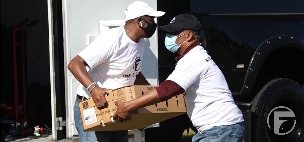 Volunteers unloading food from a truck.