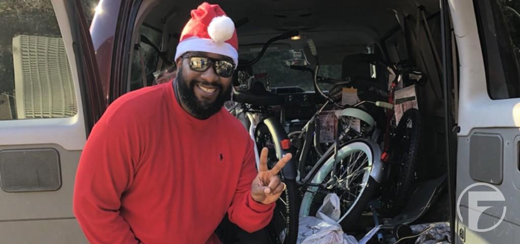 A volunteer delivering bicycles for the holidays.