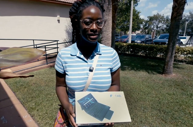 A community member receiving a Figgers tablet.